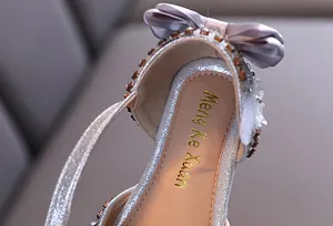 Close-up of girl's princess sandal with lavender bow and sparkling rhinestones