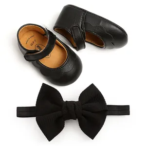 Set of black PU leather baby shoes with matching large ribbed bow headband for infants