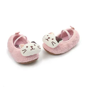 Detail of pink fluffy baby walking shoes with cute cartoon cat face decoration