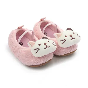 Detailed view of pink fuzzy baby shoes featuring a cute cartoon cat face design.