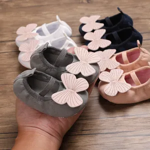 Detailed macro shot of large pink butterfly decor on soft-sole baby girl walker shoes