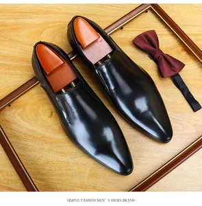 Detail view of elegant black pointed-toe leather dress shoes with a polished finish