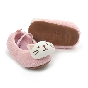 Close-up of pink fuzzy baby pre-walker shoes with cute cartoon cat face detail