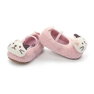Close-up of pink fluffy baby shoes with cute embroidered cat face detail