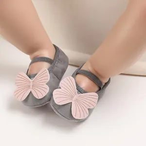 Detailed view of grey baby walker shoes with decorative pink butterfly embellishment