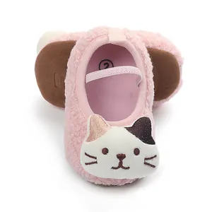Close-up of pink sherpa baby walking shoes featuring a cute cartoon cat embroidery