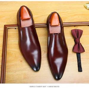 Top view of elegant burgundy men's business leather shoes with a matching silk bow tie
