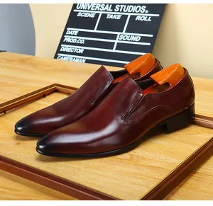Detailed view of premium burgundy leather slip-on dress shoes with a sharp pointed toe.