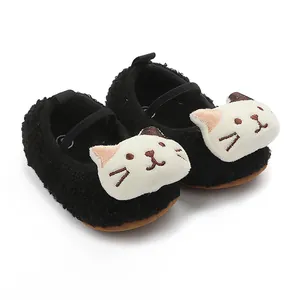 Close-up detail of fuzzy black baby walking shoes featuring a cute white cat face.