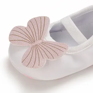 Detailed macro view of white baby girl pre-walker shoe with pink butterfly appliqué