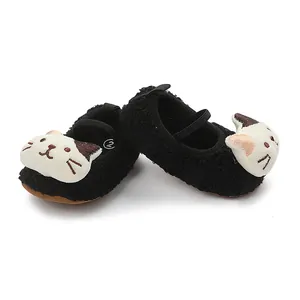 Close-up of black baby walking shoes with cute 3D cartoon cat design on toes