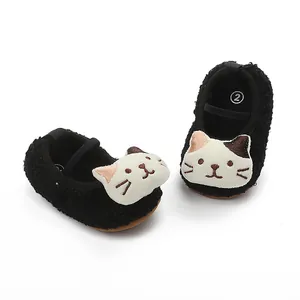 Detail view of soft plush baby walking shoes with cute cartoon cat face embroidery.