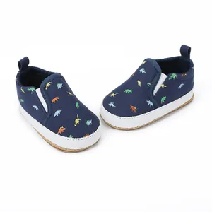 Detailed view of navy baby dinosaur loafers with white rubber soles for toddlers