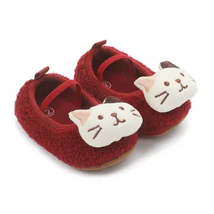 Detailed view of soft red plush baby shoes with a cute 3D cartoon cat face design