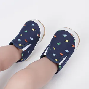 Close-up of navy blue baby slip-on shoes with colorful dinosaur patterns