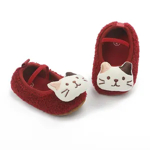 Detail of soft fleece baby slippers with cute cartoon cat face design