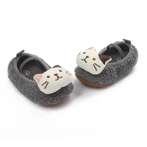 Close-up of grey fuzzy baby walking shoes featuring a cute plush cat face detail