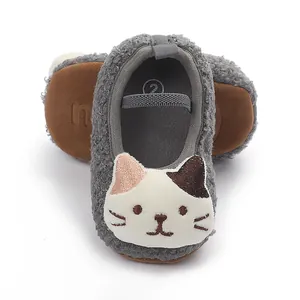 Detailed view of gray fuzzy baby walking shoes featuring a cute cartoon cat face