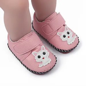 Detailaufnahme von rosa Baby-Lauflernschuhen mit weißem Kätzchen-Aufnäher und Gummisohle