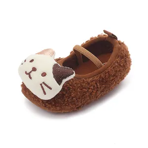Cozy brown plush baby toddler shoes with a cute 3D cartoon cat face on white background.