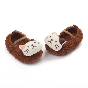 Detail of brown plush baby pre-walker shoes featuring a cute cartoon cat face design