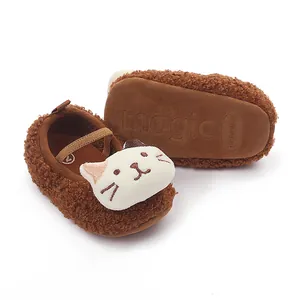 Close-up of brown plush baby walking shoes with white cat face and non-slip sole