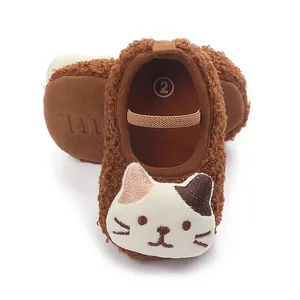 Close-up of brown fleece baby walking shoes featuring a cute cartoon cat face design.