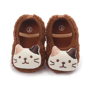Soft brown plush baby walking shoes with a cute cat face design for autumn and winter seasons.