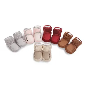 Close-up of colorful plush baby winter boots with soft soles for learning to walk.