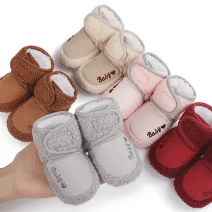 Soft plush-lined baby winter booties in various colors including pink, grey, and red