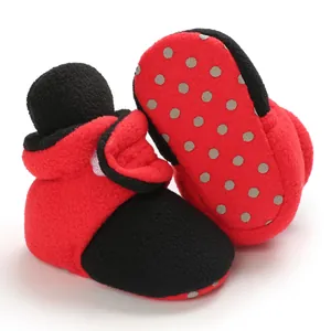 Detail view of soft fleece baby shoes with non-slip soles and Velcro closure