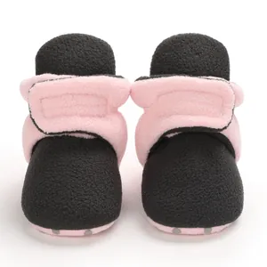 Front view of soft fleece baby booties in pink and black with secure wrap closure
