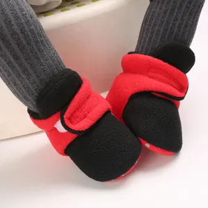 Cozy red and black baby winter boots featuring soft soles and velcro strap closure