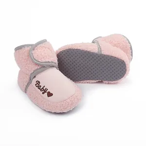 Close-up view of pink fleece baby boots with anti-slip dotted sole for 0-1 year old infants