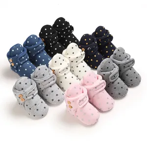 A collection of colorful soft-sole baby winter booties with star patterns and buttons.