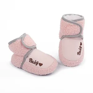 Close-up of soft pink fleece baby winter boots featuring Baby heart embroidery detail