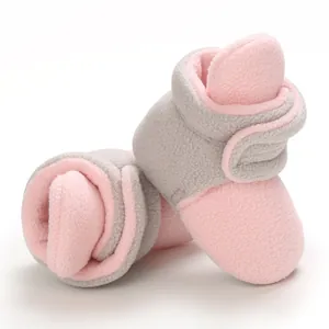 Detailed view of soft pink and grey fleece baby booties for infants aged 0-1 year.
