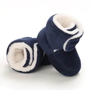Gros plan détaillé des bottes en velours côtelé bleu marine pour bébé avec doublure