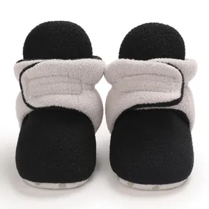 Close-up of soft fleece baby winter boots with grey and black color block design