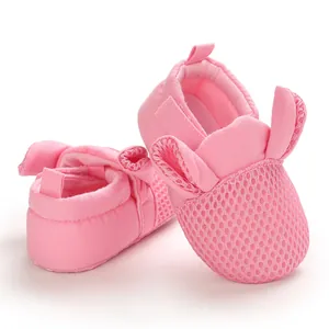 Dettaglio di scarpine da neonato rosa in mesh traspirante con orecchie di coniglio
