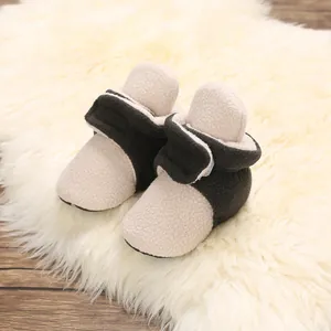 High-quality detail of soft-soled baby fleece winter booties with a stylish color block design