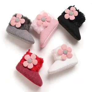 Detail view of colorful fleece-lined baby winter snow boots with pink flower decoration