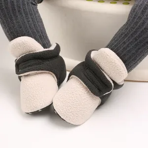Macro detail of soft-sole baby fleece winter shoes with contrast color strap and Velcro