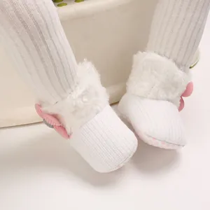 Warm white fleece-lined baby snow boots with pink bow detail for 0-1 year old infants