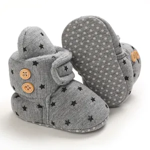 Detail of grey star-patterned baby snow boots with warm fleece lining and soft anti-slip sole