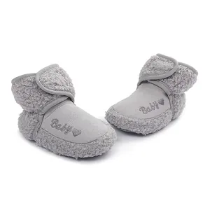 Close-up of gray baby winter boots with "Baby" embroidery and soft faux fur lining.