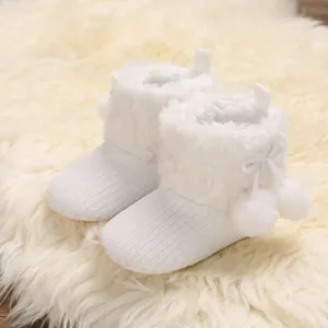 Soft white baby princess boots featuring cute pom-poms and plush faux fur trim detail