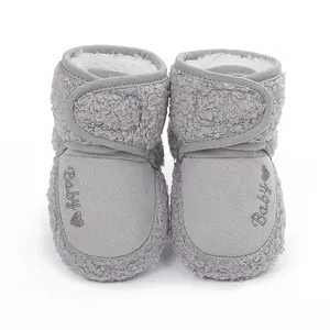 Detailed view of grey baby winter boots with warm plush lining and embroidery