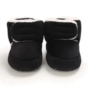 Détail de bottes de neige pour bébé en velours noir avec doublure polaire.