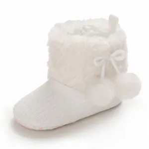 Adorable white knit baby girl boots with fluffy fur trim and pom-poms for 0-1 year old
